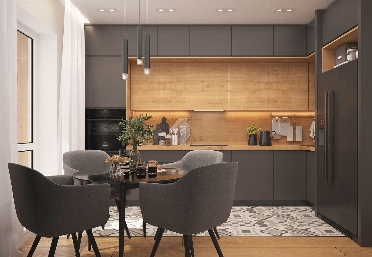 Vue intérieure d’un appartement meublé avec cuisine équipée et table à manger. LMNP résidence gérée